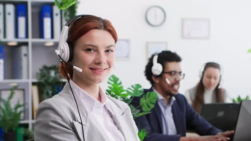 Portrait of Young Beautiful Woman with Headset Working As Call Center Operator and Answering Calls
