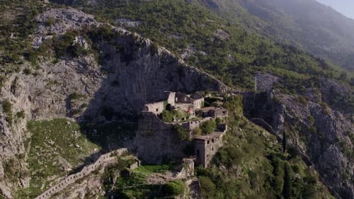 Aerial view of medieval ruins and fort overlooking Kotor Bay, Montenegro.