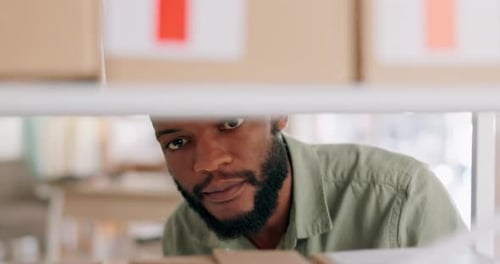 Man Inspecting Boxes in Warehouse Close Up