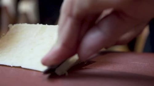 Close-up selective focus of cheese slicing in triangle shape for Tapas