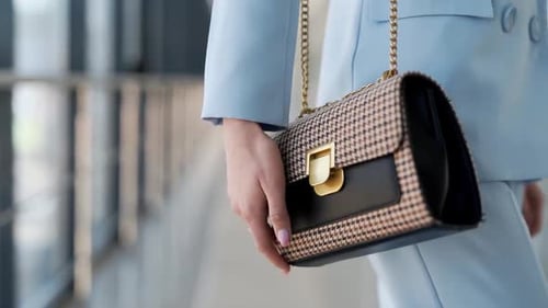 Close-up of a women's handbag on a girl in a blue suit