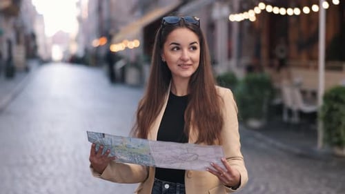 Woman Studies Map on Cobblestone Street