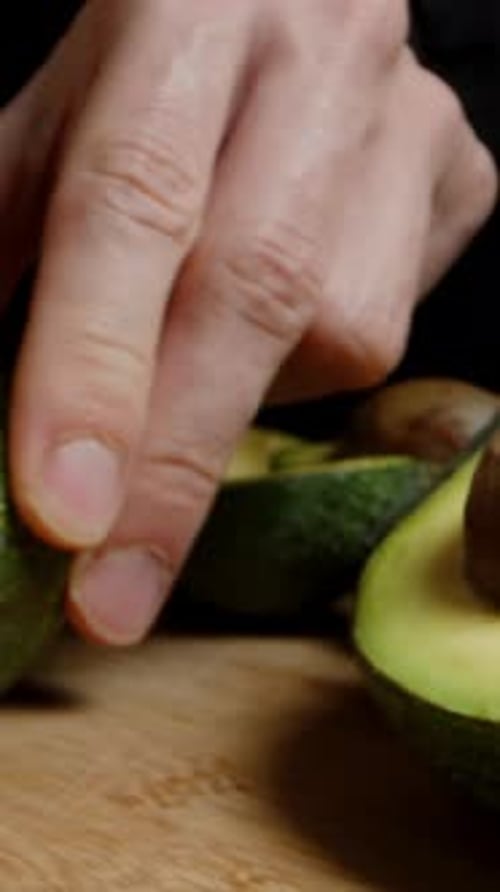 Avocado Being Cut on Cutting Board in Kitchen