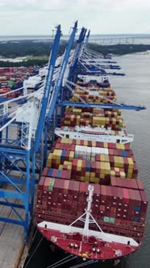 Crane Loading Cargo Container to Container Maritime Ship in the International Terminal Container