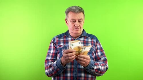 Senior Man Counting Cash of 50 Euro Money Banknotes and Smiling Pleased