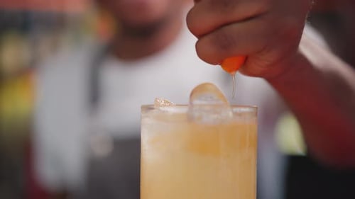 Bartender Squeezing Citrus into Refreshing Cocktail Drink