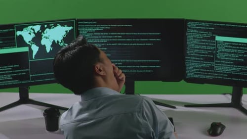 Tired Asian Man Yawning Before Sleeping While Write Code With Multiple Computer In Green Screen