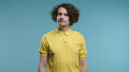 Man Shakes Head in Disagreement on Blue Background