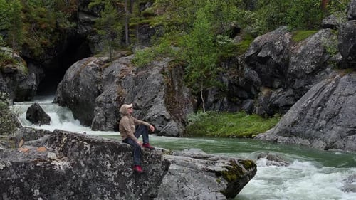 Enjoying Nature by the Rushing River in a Scenic Rocky Landscape