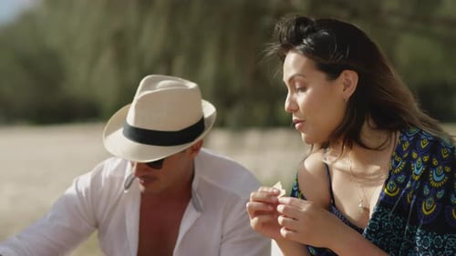 Sexy Millennial Friends Eat And Drink On Sandy Beach Under Sunny Blue Sky In Australia. Closeup T...