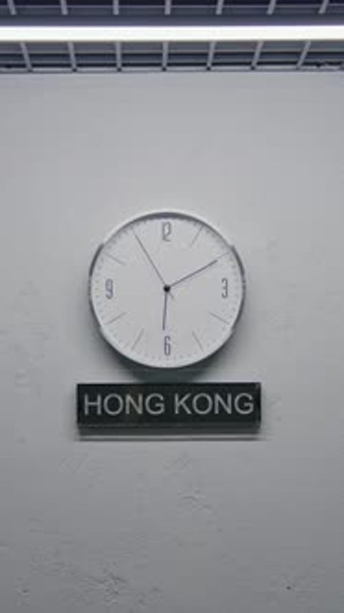 White Wall Clocks Illuminated By Lamp in Office