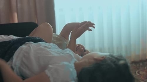 Child and Adult Lying Together on a Bed