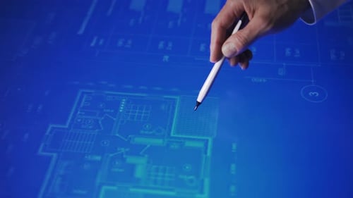 A Human Hand Moves a Drawing with a Stylus on an Touchscreen Monitor