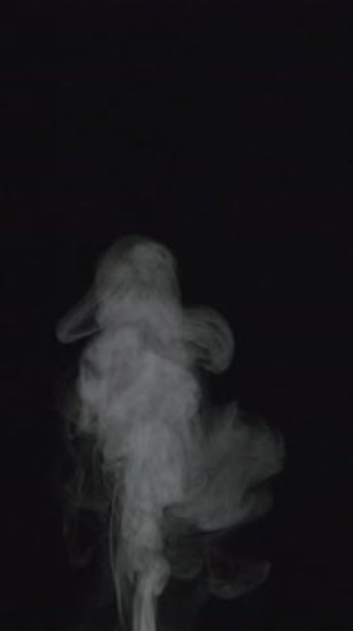 Abstract Wispy Smoke Rising on Black Background
