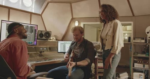 Band Composing with Producer in Music Recording Studio