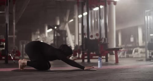 Muslim Sportswoman Stretching Back in Gym