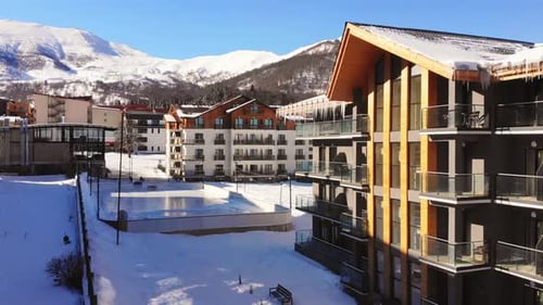 Ice Skating Ground With Hotel Buildings In Ski Resort