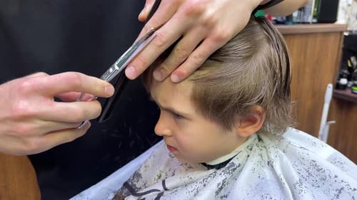 Child Getting a Haircut at a Barbershop
