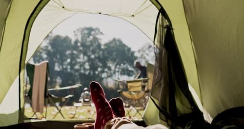 Relaxing Person Resting Inside Tent While Camping
