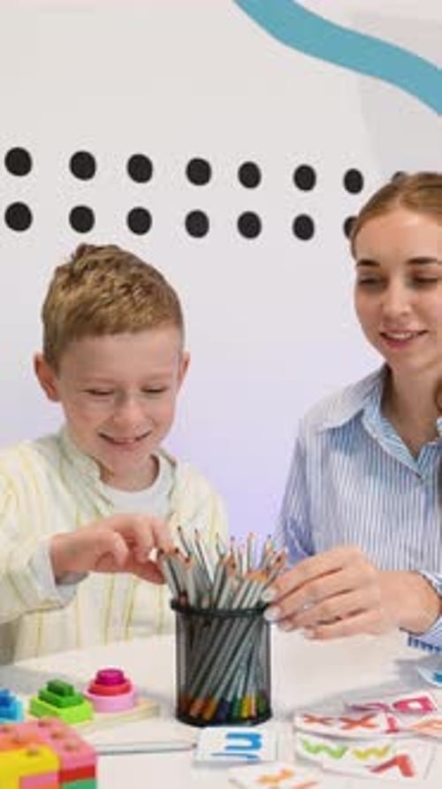 Child Psychologist Working with Young Boy During Therapy Session