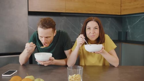 Couple Eats Cereal Together in Modern Kitchen