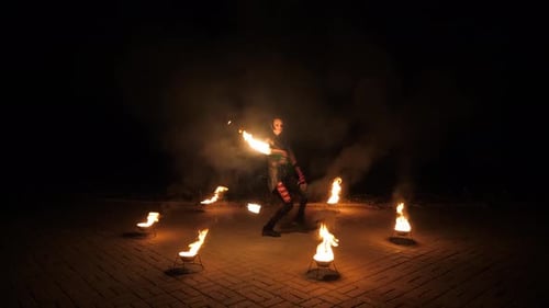 Woman Performs Fire Dance at Night