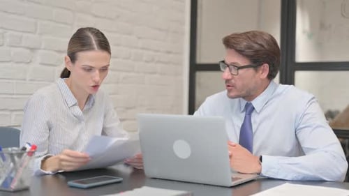 Business People Discussing Business Report in Office