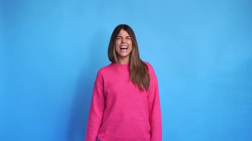 Woman Expressing Strong Emotions on Blue Background