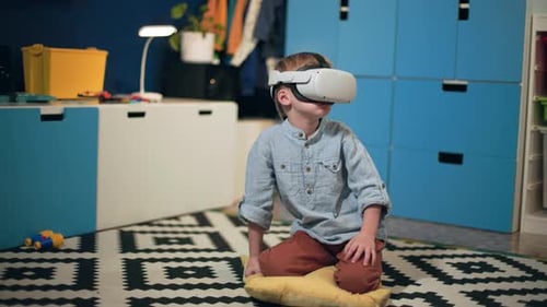 Young Boy Interacts with Virtual Reality Headset at Home