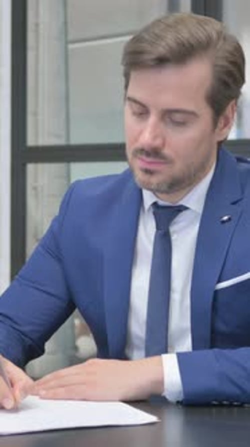 Mature Adult Businessman Writing a Letter in Office, vertical video