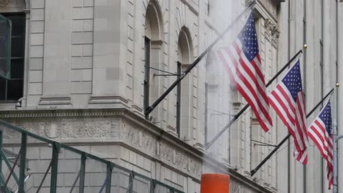 Flags Waving Outside Building in American City