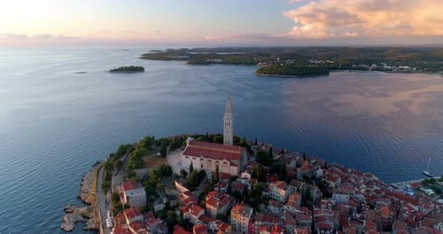 Rovinj, Croatia aerial pull back shot over St. Euphemia Church at sunset