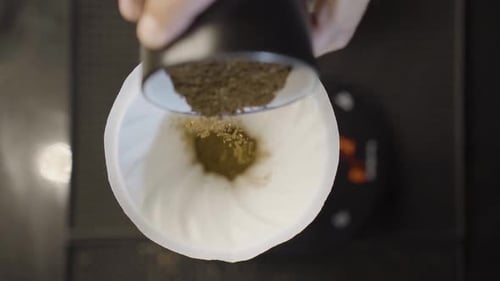 Pouring Ground Coffee into Cloth Filter