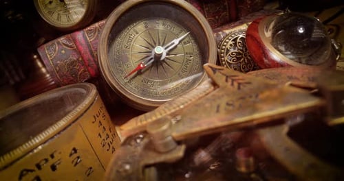 Vintage style travel and adventure. Vintage old compass and other vintage items on the table.