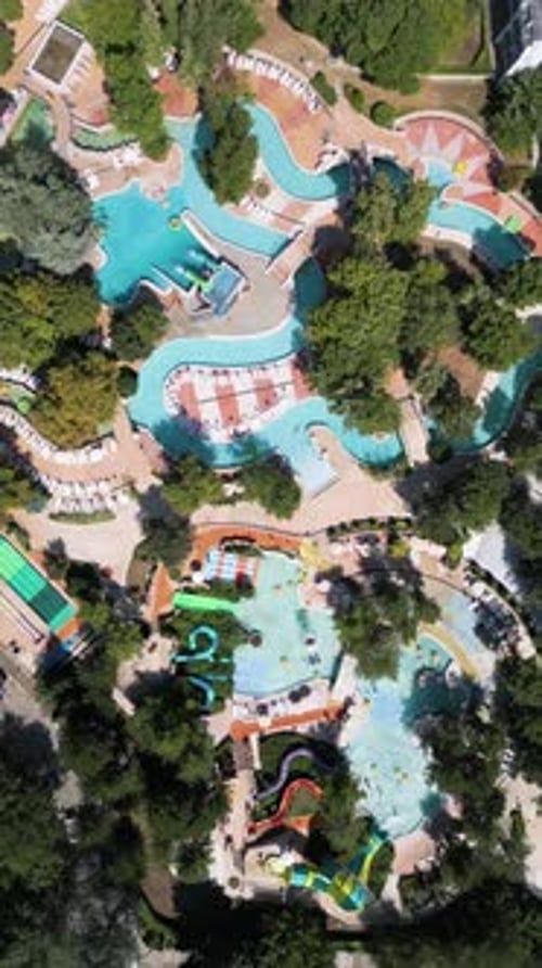 Aerial View of a Relaxing Water Park with Interconnected Pools Lazy Rivers and Small Slides