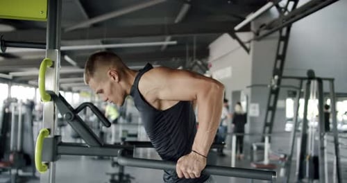 Young Man Performing Intense Physical Workout at Modern Gym