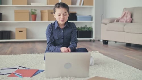 Girl Attends Class on Laptop Computer at Home