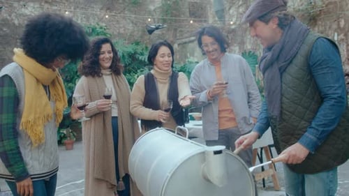 Adults chatting and smiling at an outdoor party