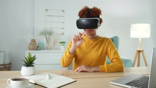 Woman Using Virtual Reality Headset at Desk