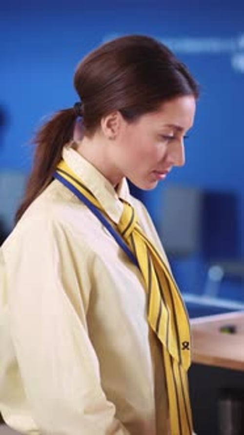 Smiling Woman in Office Wearing Yellow Tie