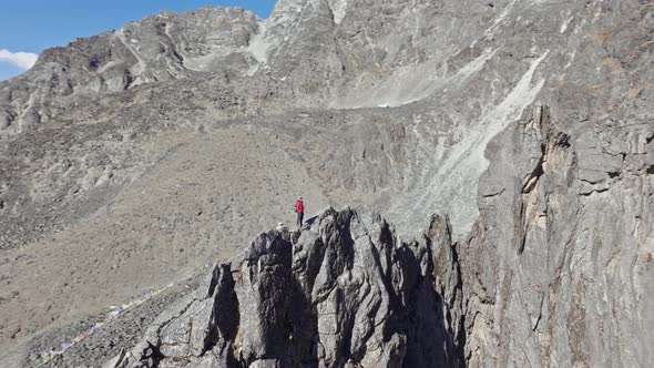 Mountain Climber Scaling Precarious Ridge Navigating Rugged Himalayan ...