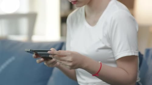 Woman Shopping Online Using Credit Card and Phone