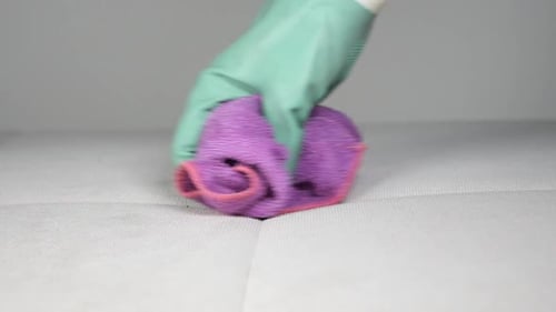 Gloved Hand Wipes Surface with Microfiber Cloth