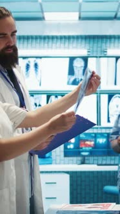 Healthcare Professionals Reviewing X-ray in Hospital Setting