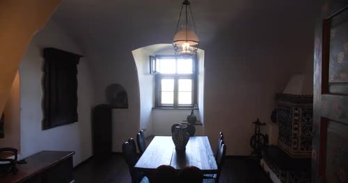 Warm sunlight coming through the window of the vintage style room inside Bran Castle.