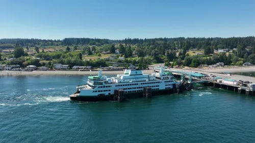 Aerial view approaching a docked ferry as it loads passengers.