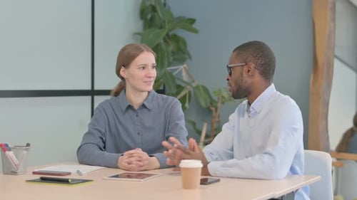 Young Business People Discussing Work in Office