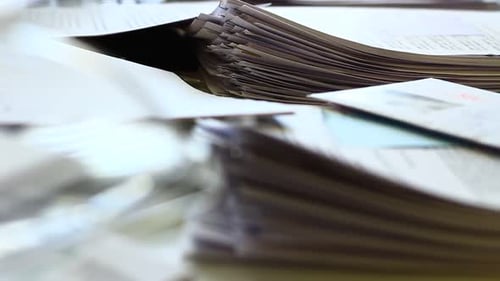 Stacks of Paperwork and Documents in Bright Office