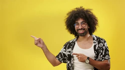 Portrait of Young Man in a Studio on Yellow Background Spinning And