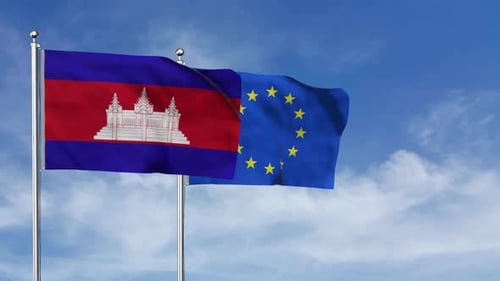 Cambodia and European Union Flags Waving Against Blue Sky
